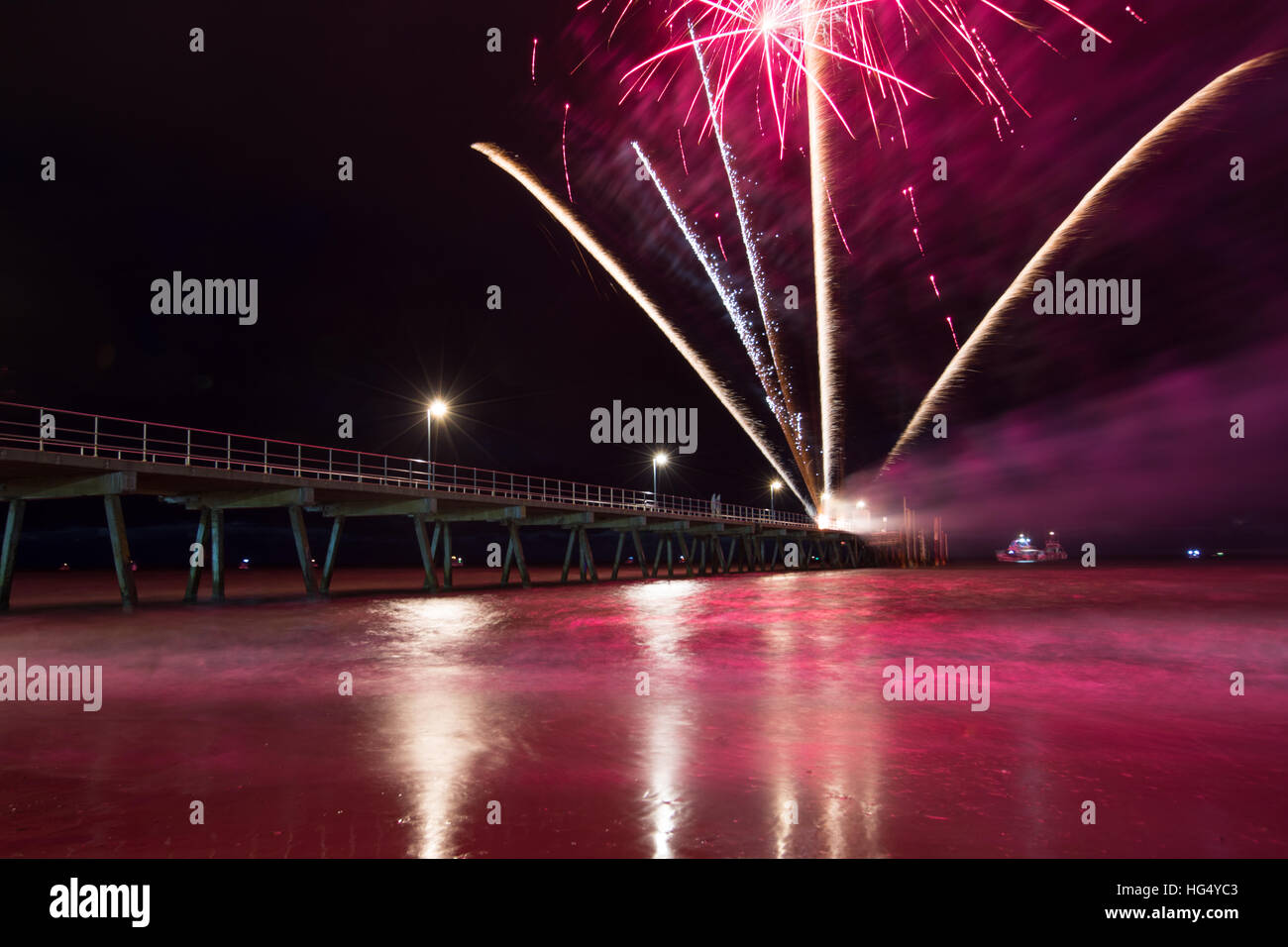 Colourful 2017 New Years Fireworks Display lighting up the sky and water off Glenelg Jetty, Adelaide, South Australia Stock Photo