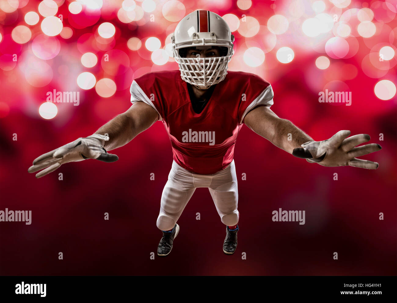 Football Player with a red uniform making a tackle on a red lights ...