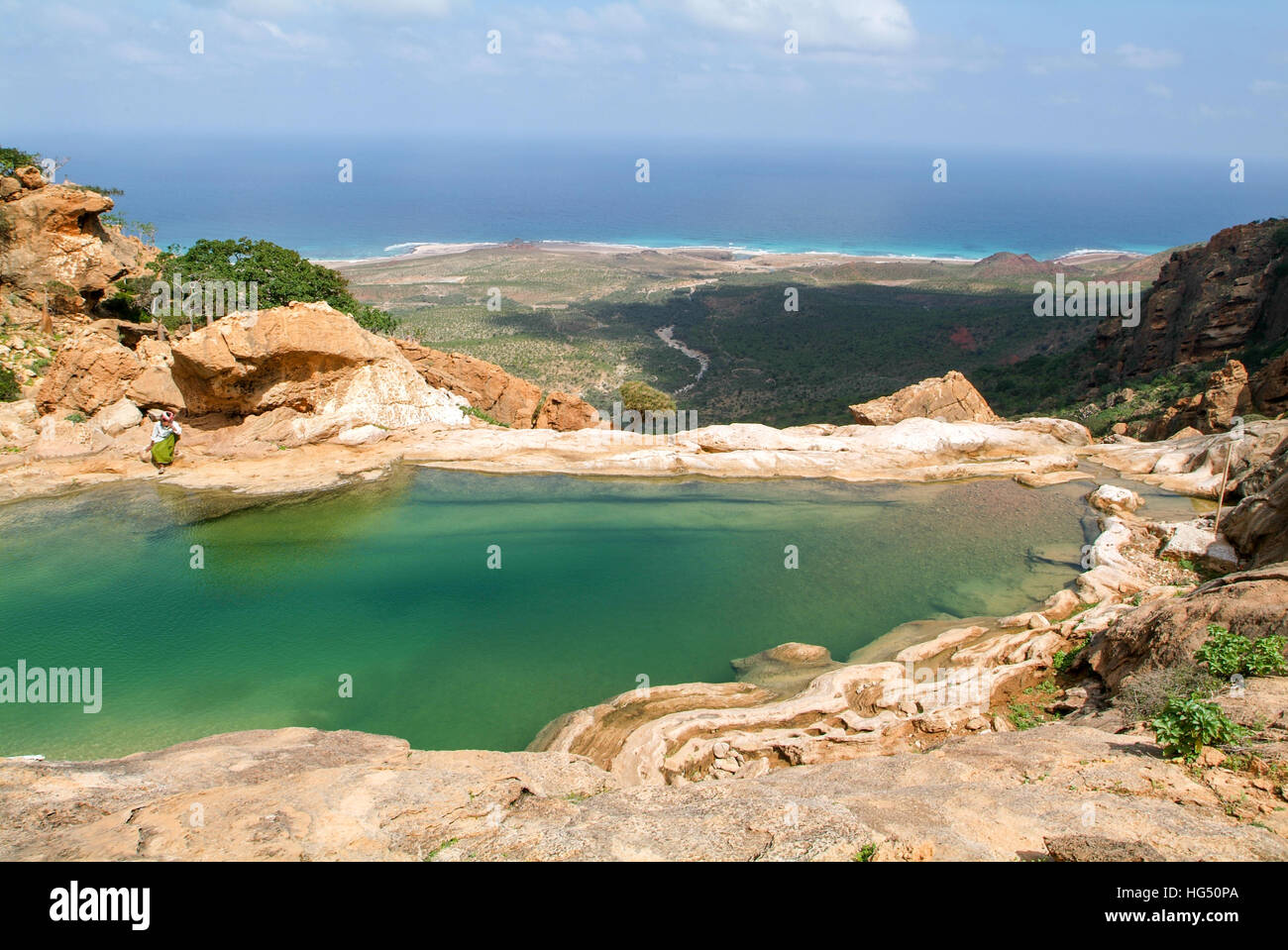 Homhil (Socotra Isalnd), Yemen - 13 January 2008: man sitting on the lakeside of Homhil mountain lake on Socotra island, Yemen Stock Photo