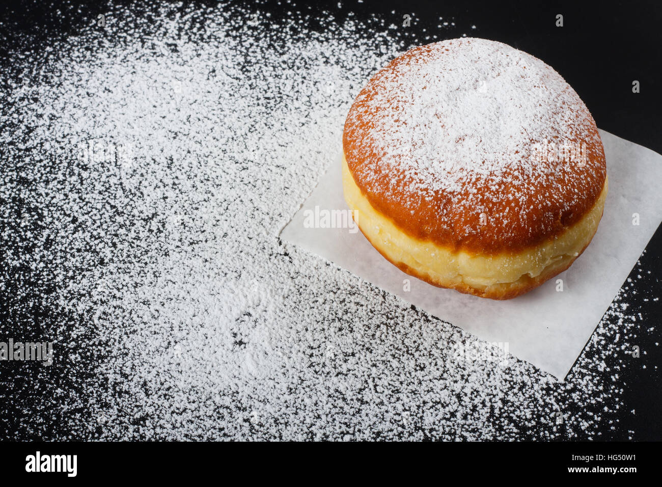 Donut and powdered sugar on dark background Stock Photo