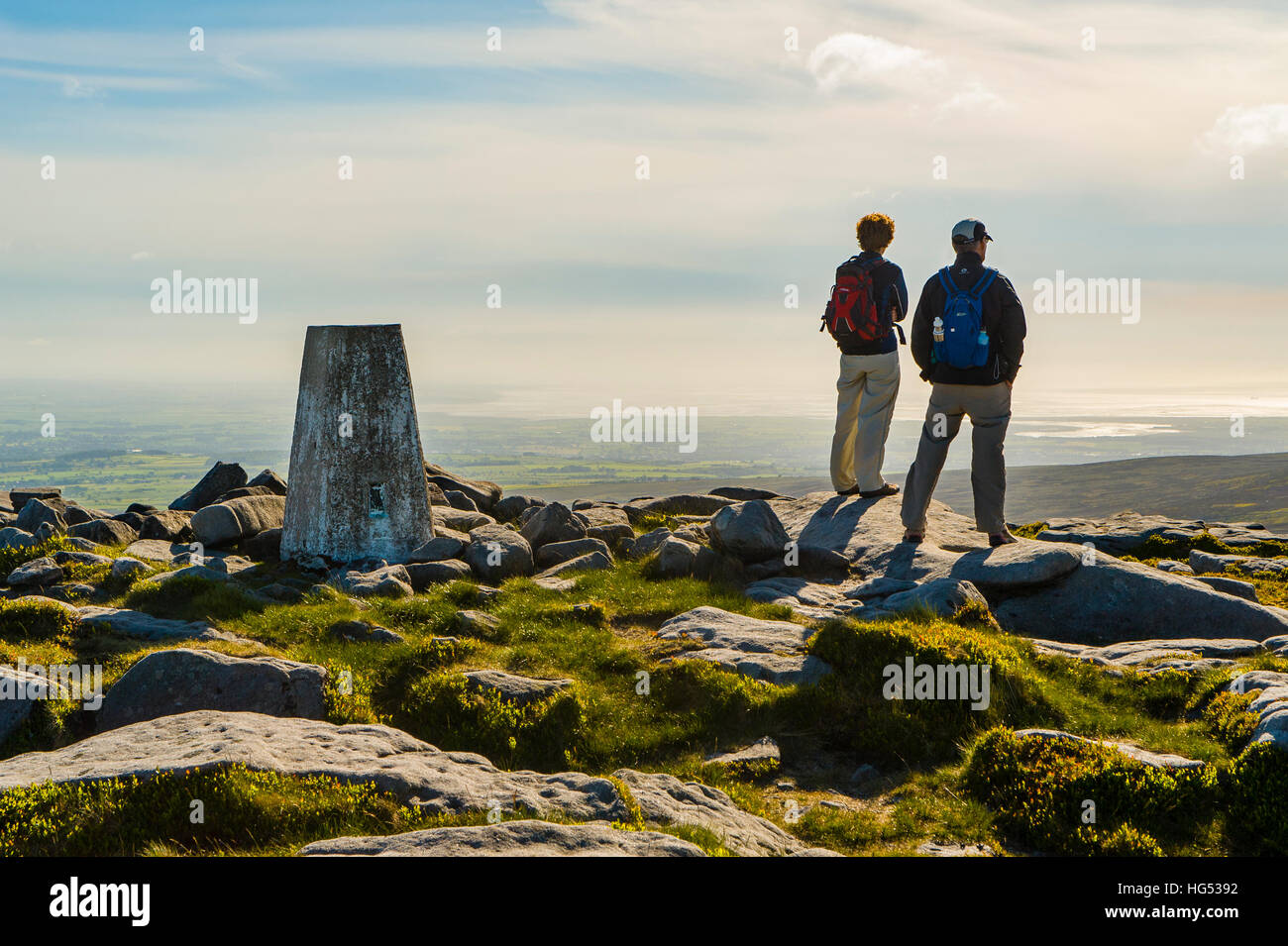 Walkers at west summit of Ward’s Stone in the Forest of Bowland Lancashire England looking towards Morecambe Bay Stock Photo