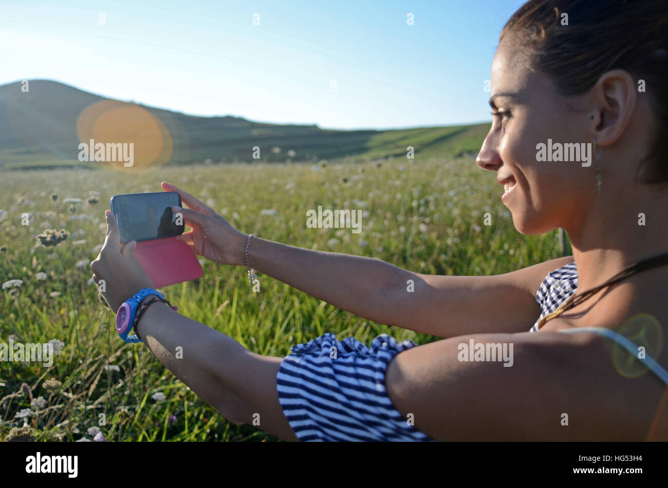 Attractive young woman takes a selfie with mobile phone Stock Photo - Alamy