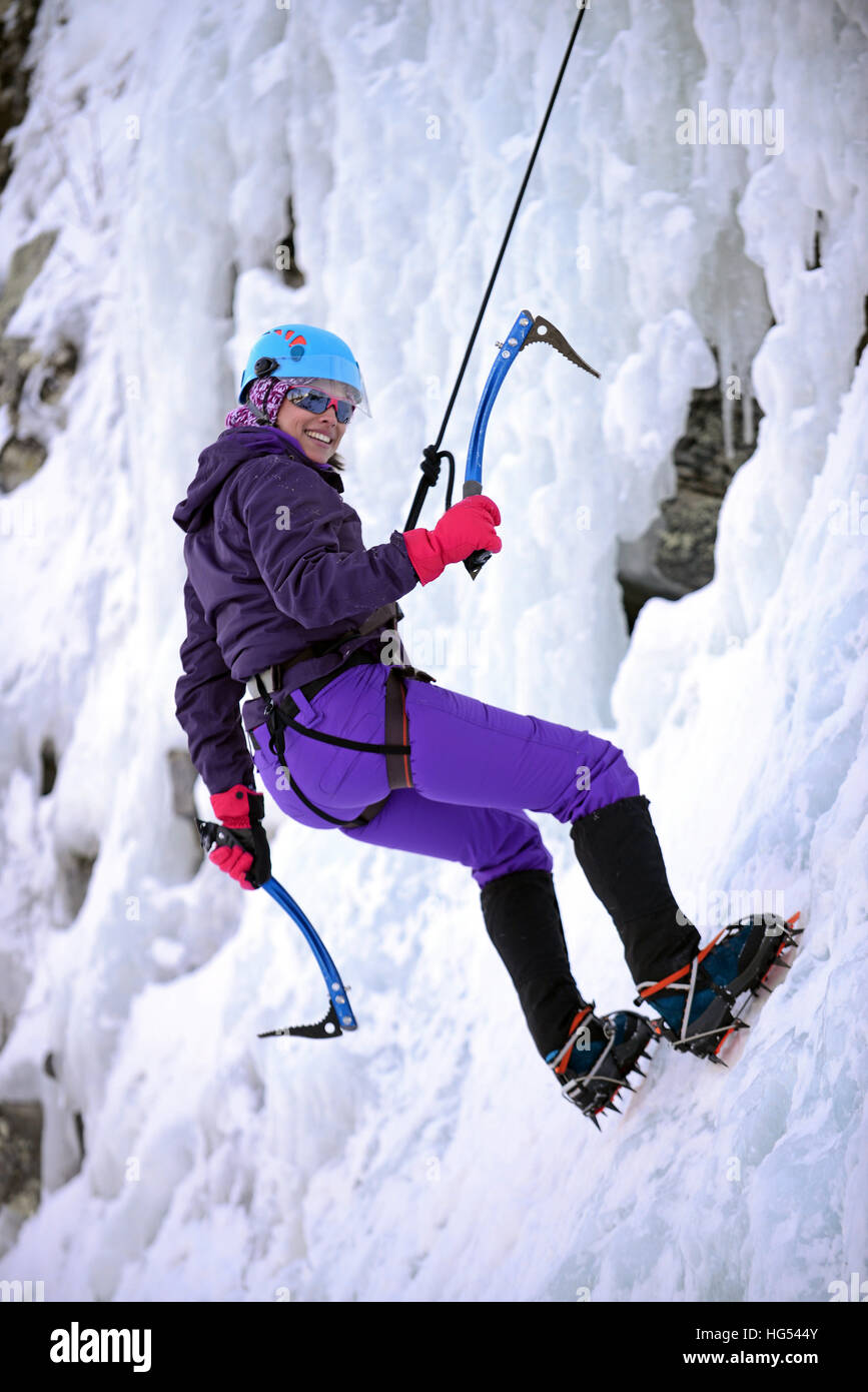 Young woman ice climbing in Pyhä, Lapland, Finland Stock Photo