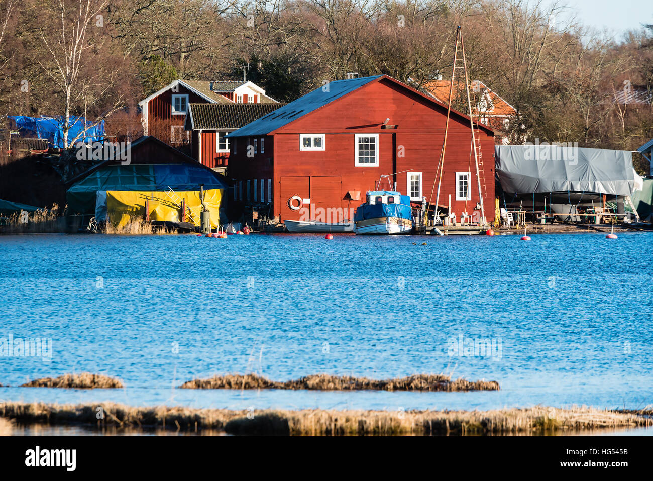 Ronneby, Sweden - January 2, 2017: Documentary of Swedish coastal lifestyle. The old shipyard at Saxemara bay as seen from across the water. Stock Photo