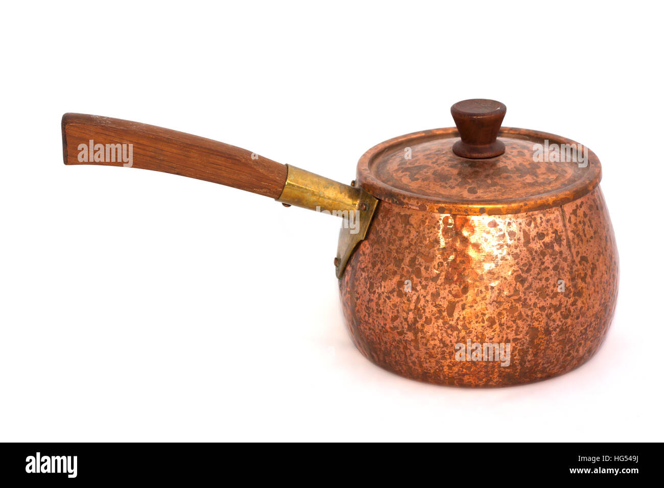 Copper pan with a wooden handle on a white background Stock Photo