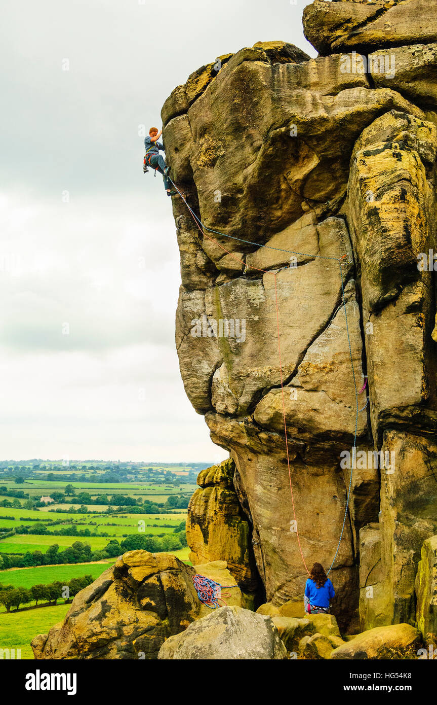 Rock-climbers on Great Western (HVS 5a) at Almscliff Crag North Yorkshire Stock Photo