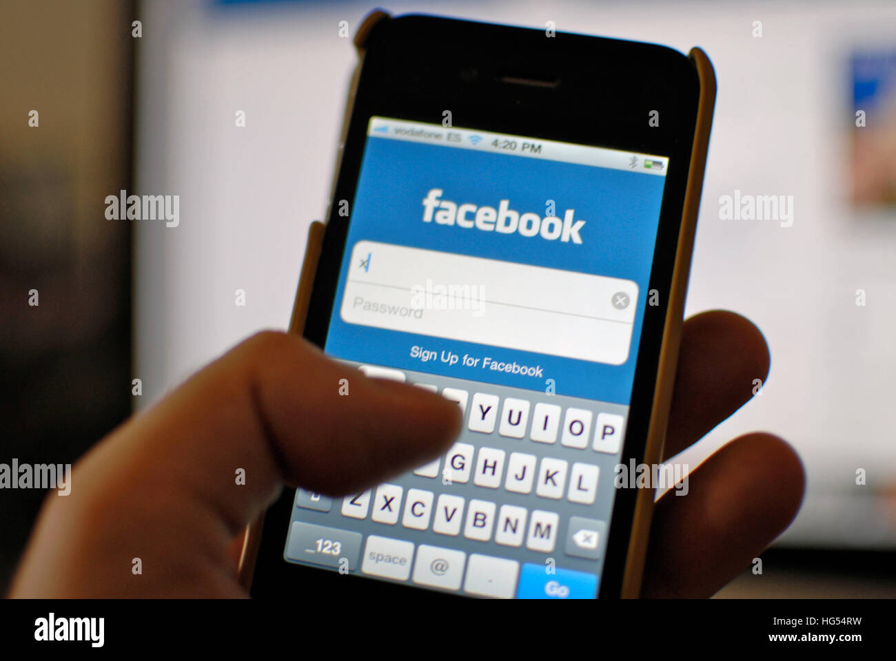 Man typing username in Facebook App for iPhone Stock Photo