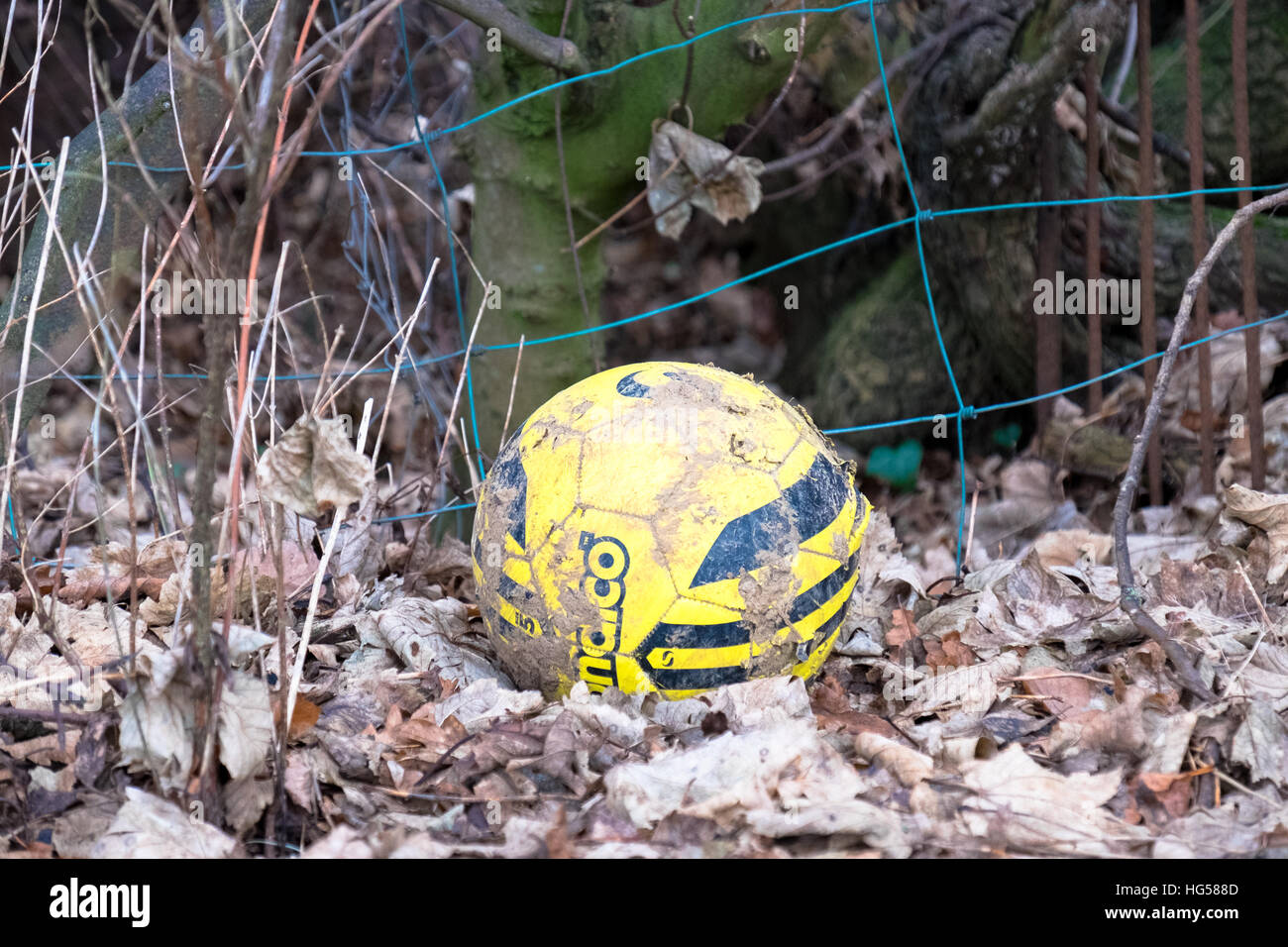 'Please can we have our ball back, Mr?' lost football over fence Stock Photo