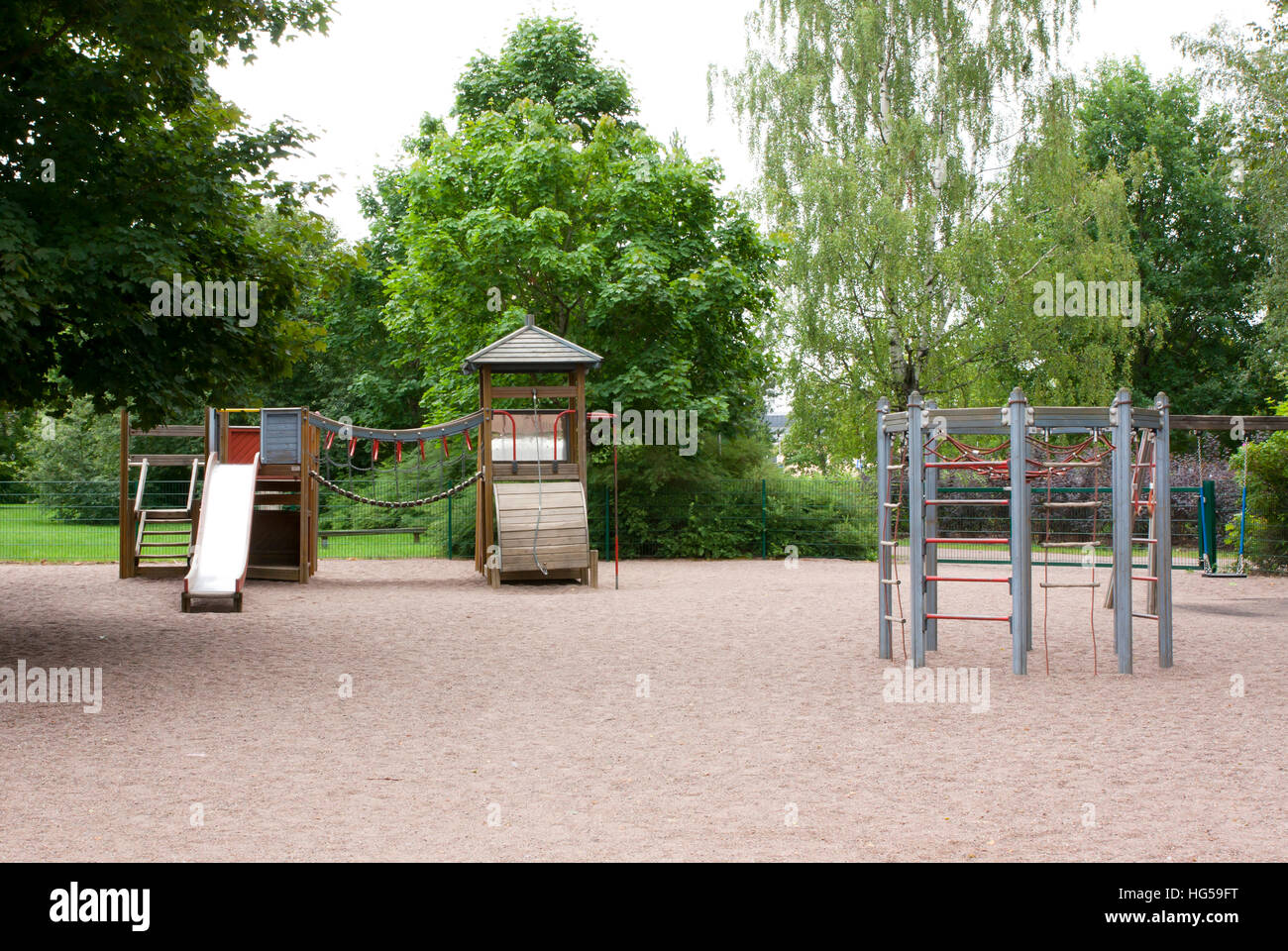Children's playground with slide, climbing frame and rocking at summer ...
