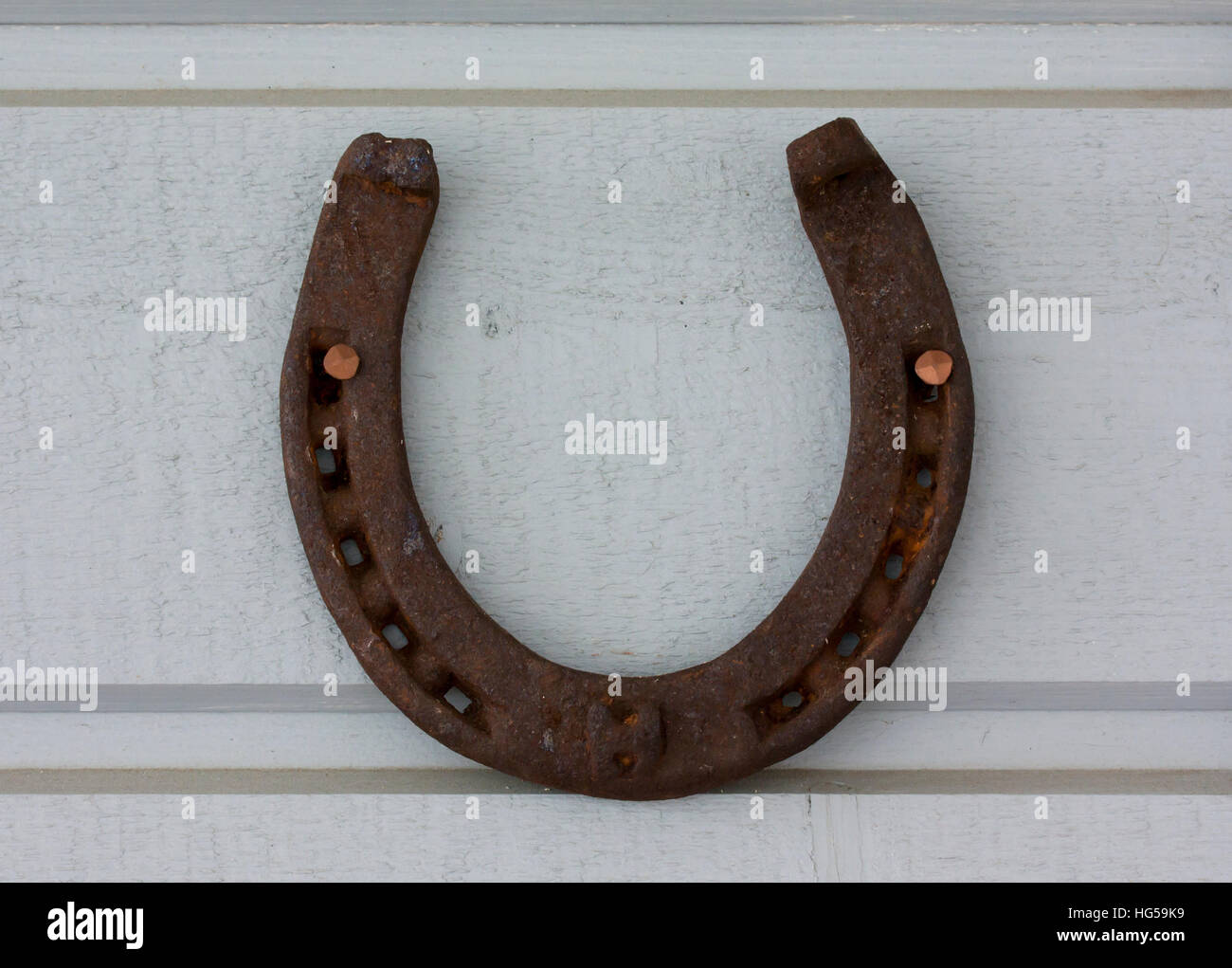 Old vintage horseshoe hanging on the wall Stock Photo - Alamy