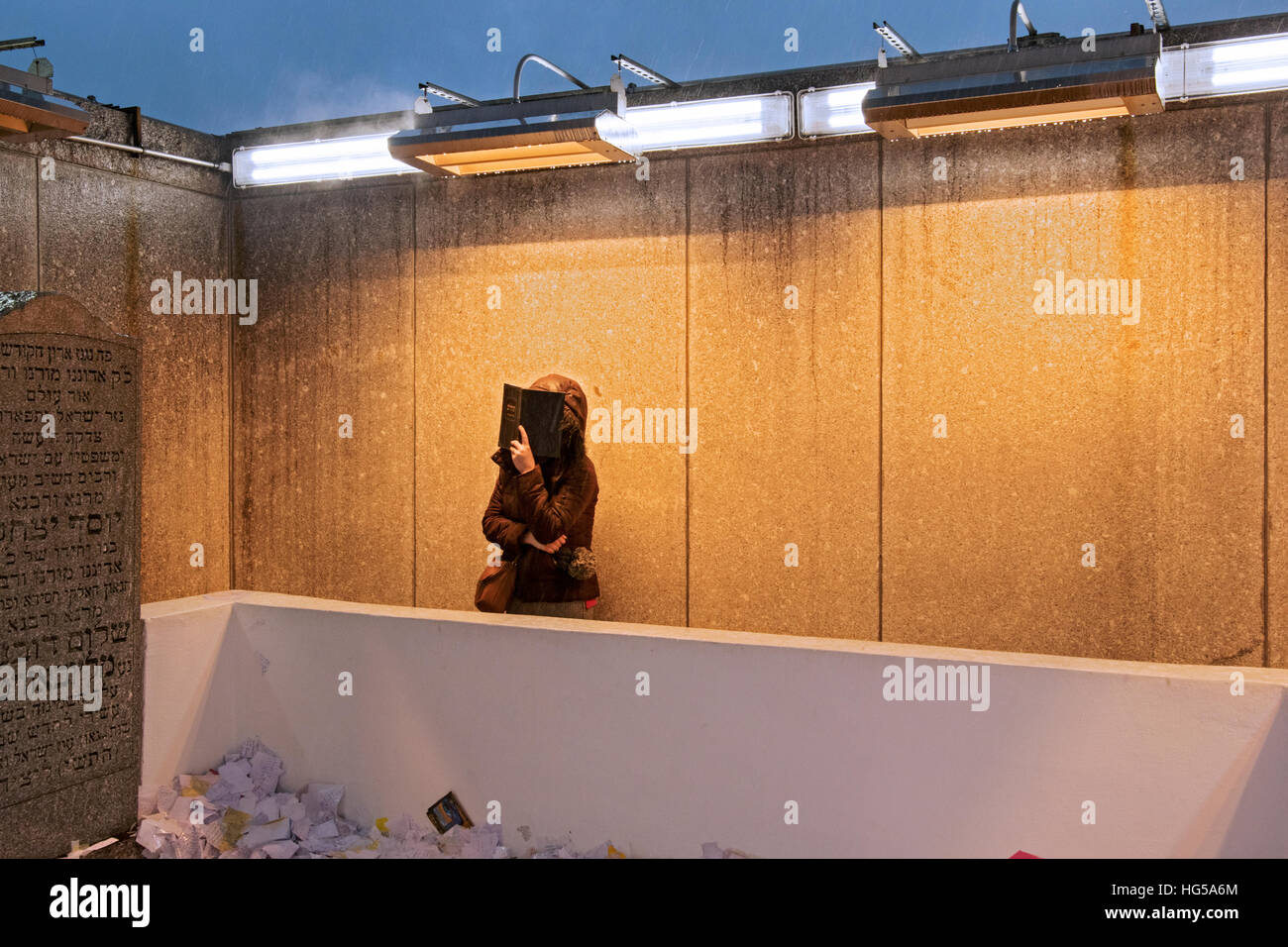 An anonymous woman praying near the headstones of the last 2 Lubavitch ...