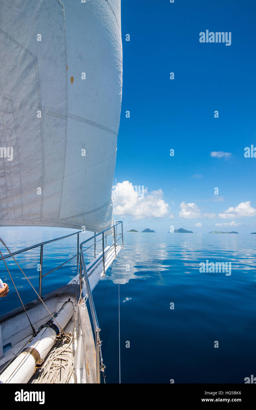 Sailing in the very flat waters of the Mamanuca Islands, Fiji, South Pacific Stock Photo