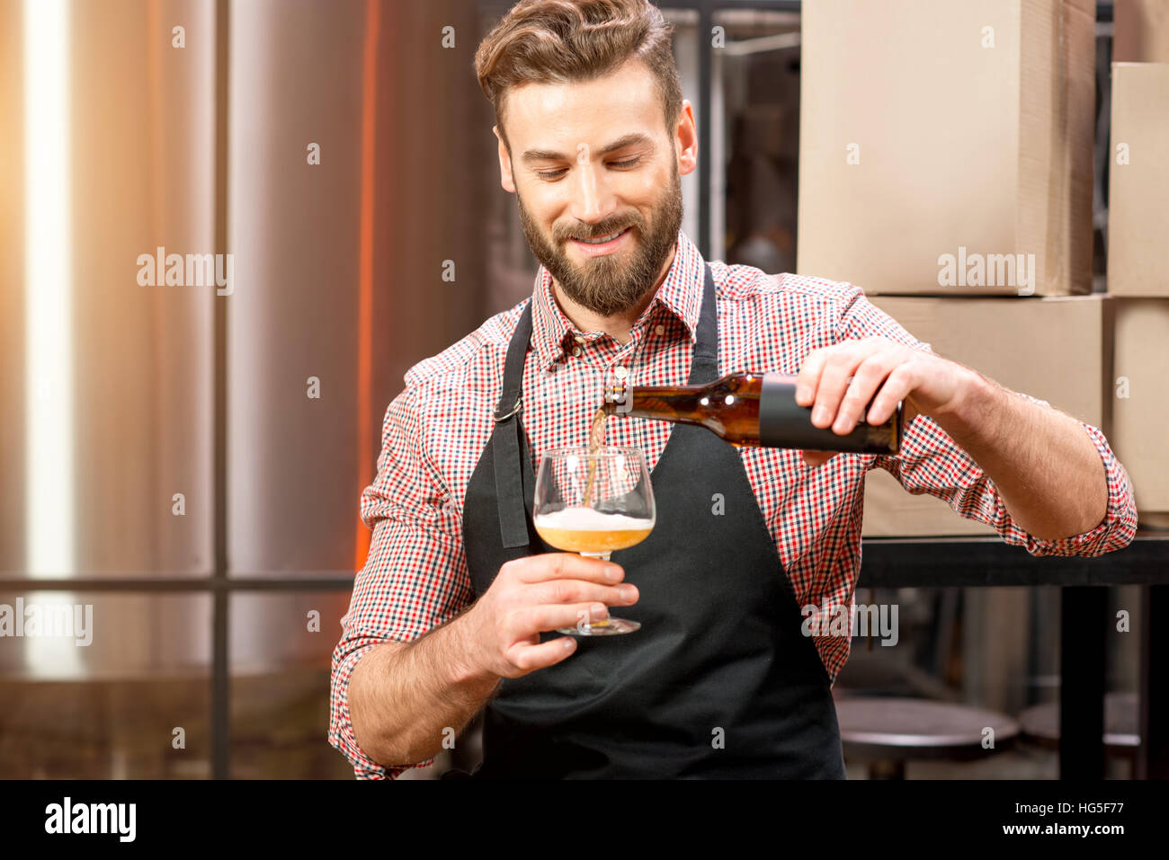 Brewer pouring beer Stock Photo