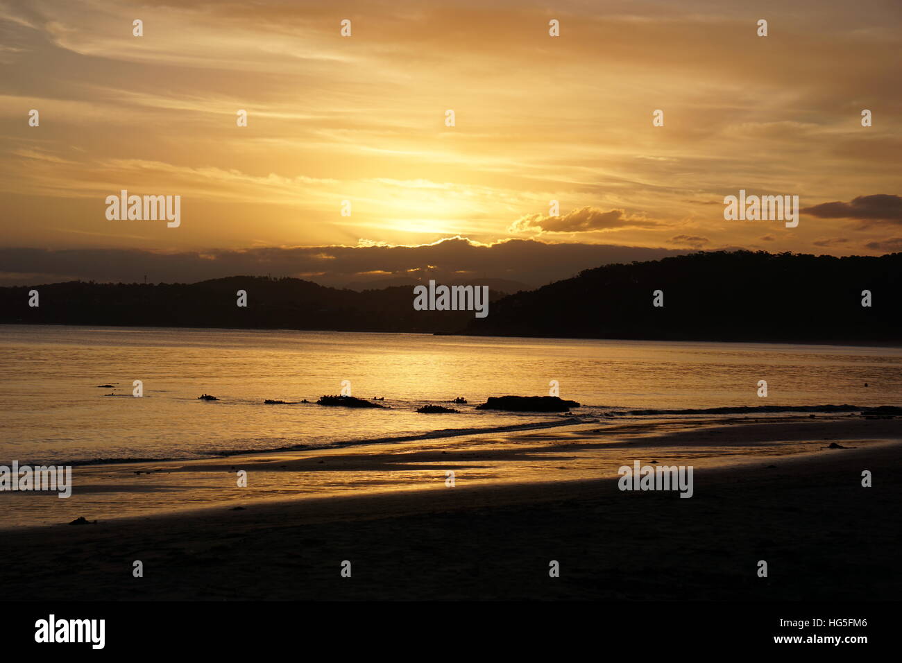 Beach Sunset Over Mountains Stock Photo - Alamy