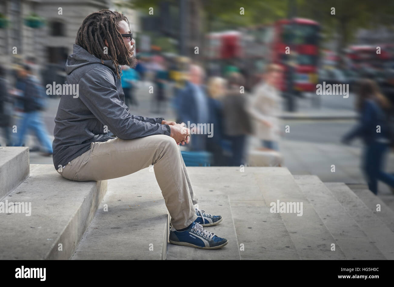 black man.  Man contemplating.   dreadlocks.  rastafarian.   Alone in the city. Stock Photo