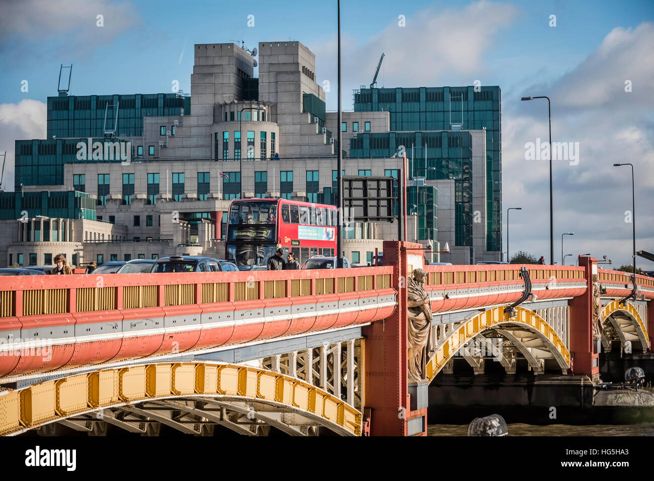 Red bus crossing Vauxhall Bridge and MI5 building, London Stock Photo
