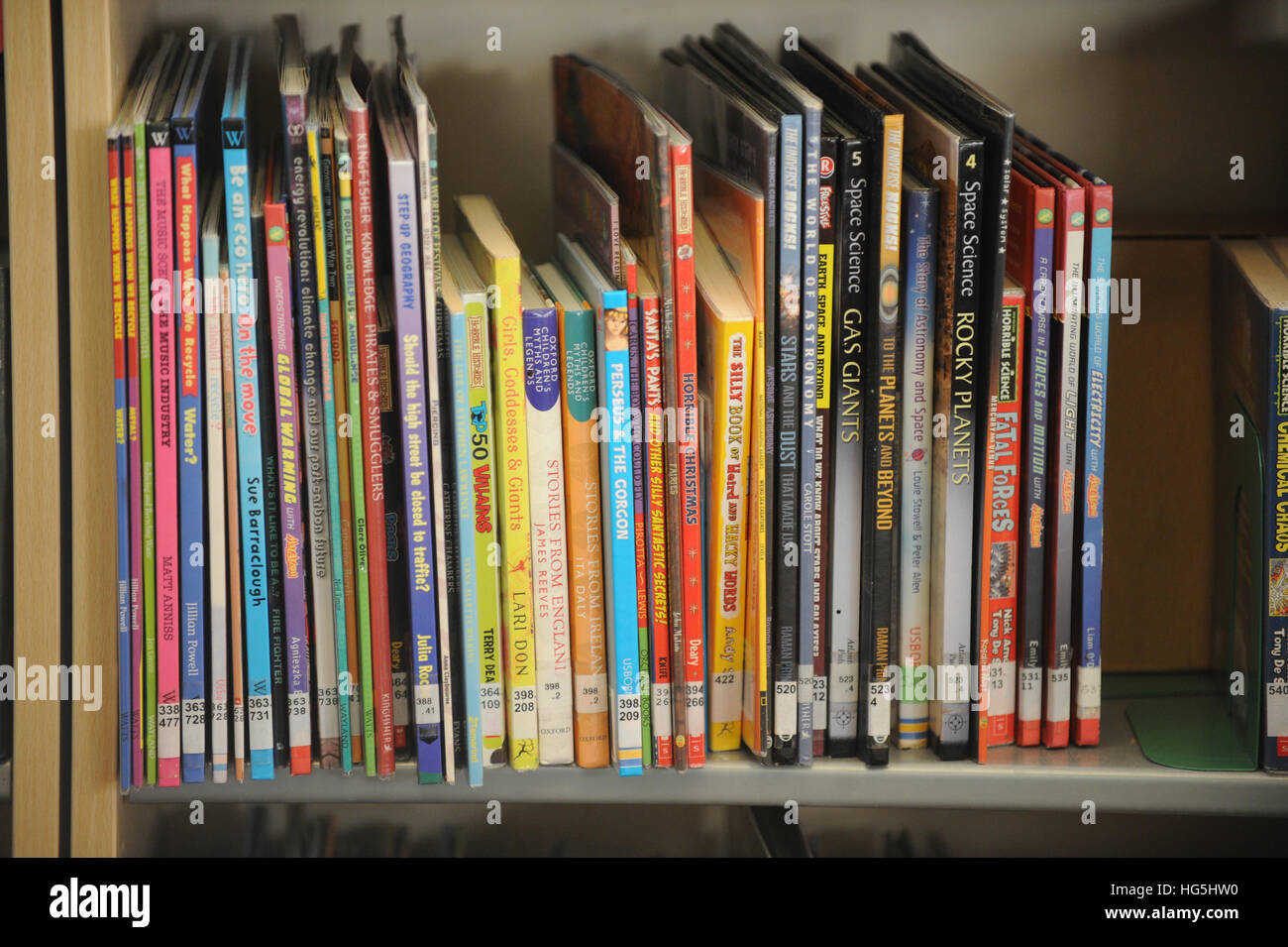 Books lines up on a library shelf. Stock Photo