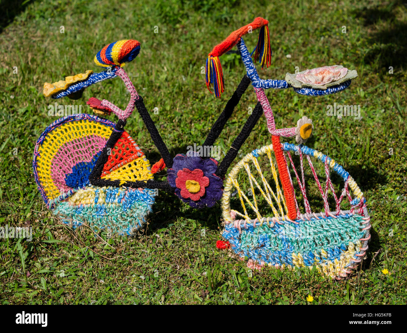 Bicycle, covered with colored knitted wool, seen in Eifel area near Daun, Germany Stock Photo