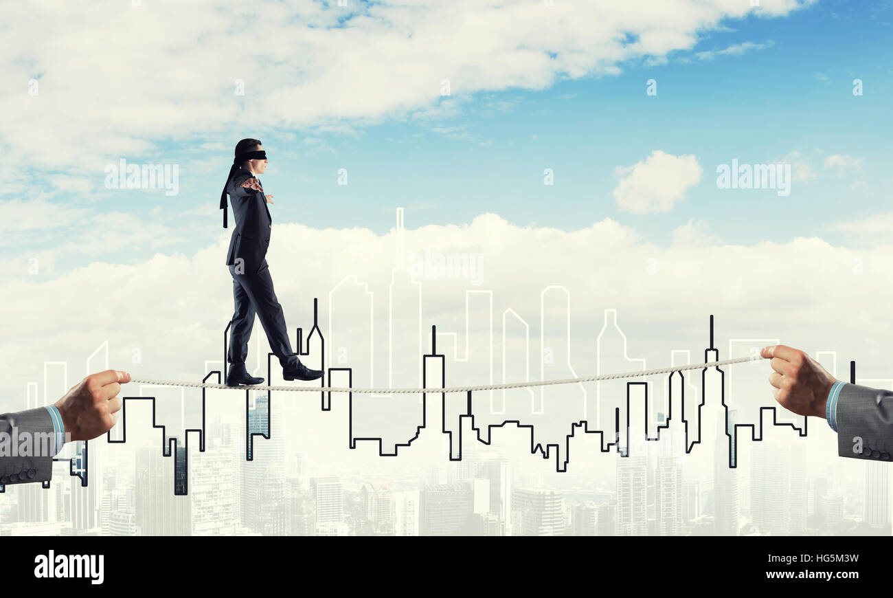 Business concept of risk support and assistance with man balancing on ...