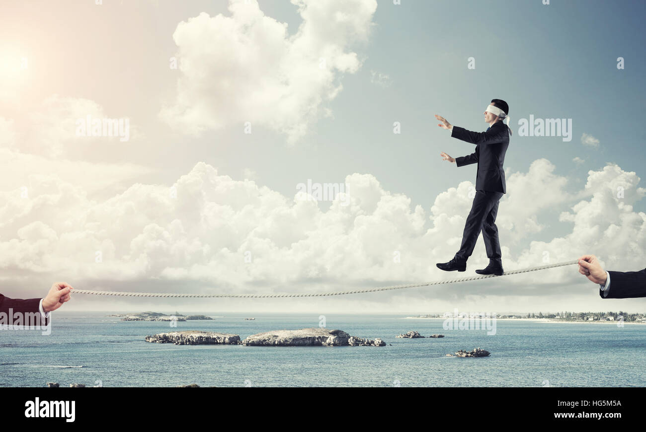 Business concept of risk support and assistance with man balancing on ...