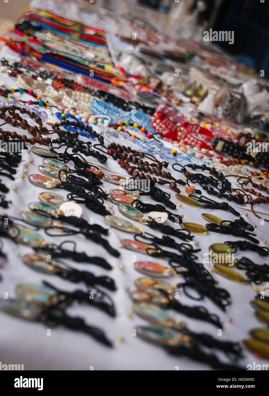 Many decorative trinkets of religious style in a street vendor Stock