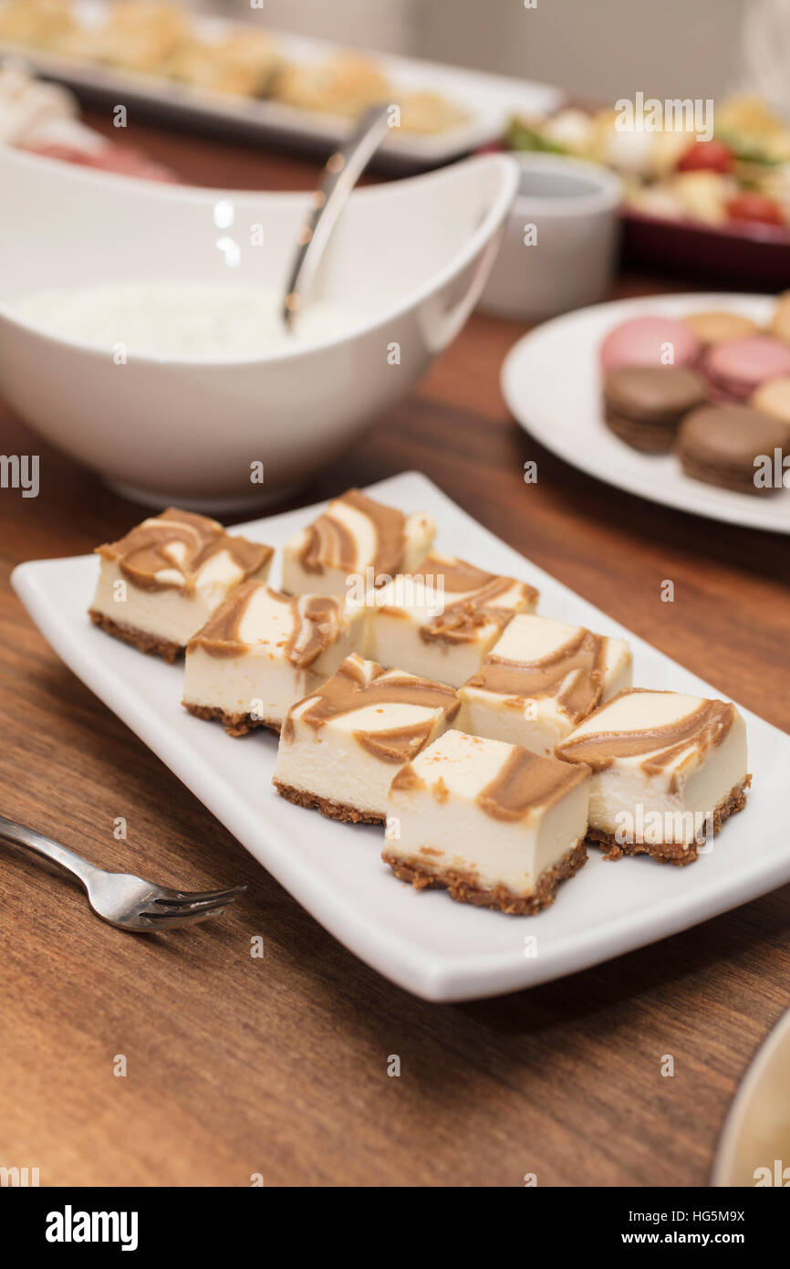 Vanilla Cheesecake squares swirled with caramel, with cold cuts and