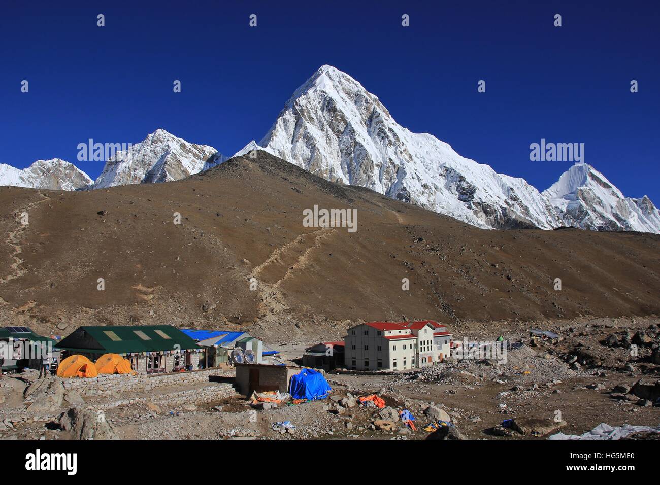 Last settlement before the Everest base camp. Popular view point Kala Patthar. Snow covered mount Pumori. Stock Photo