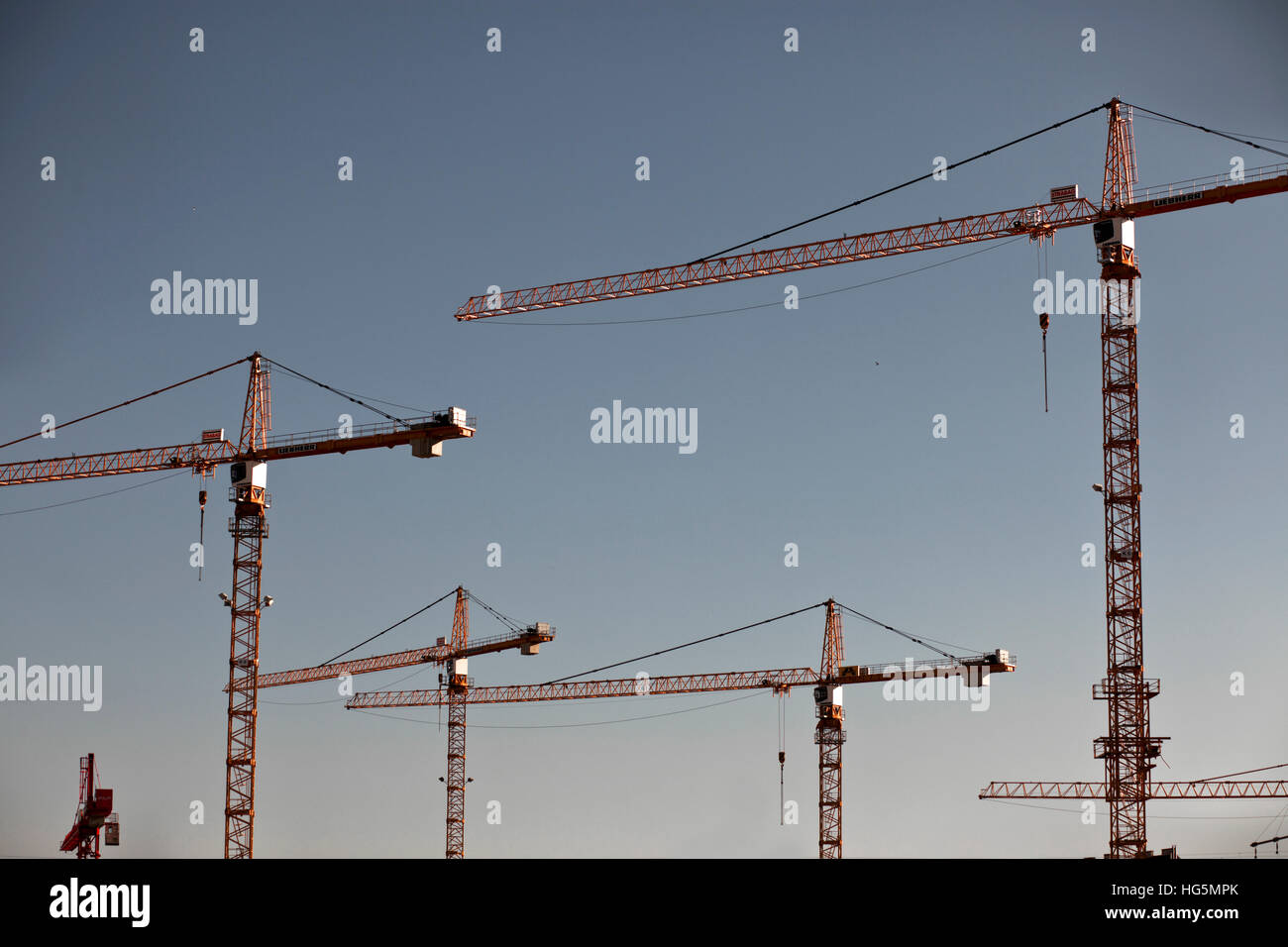Construction cranes against evening hi-res stock photography and images ...