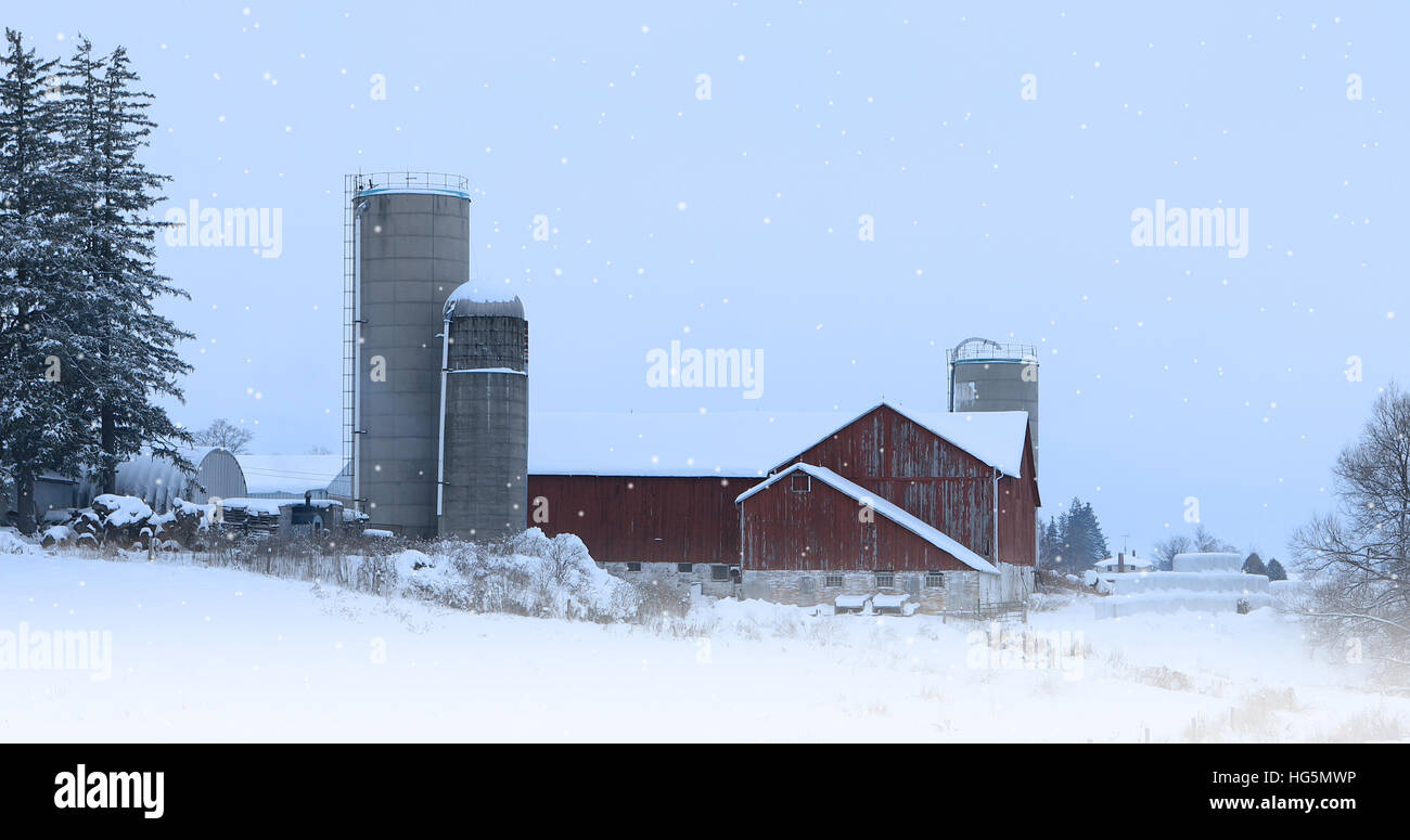 A Red barn with falling snow Stock Photo - Alamy