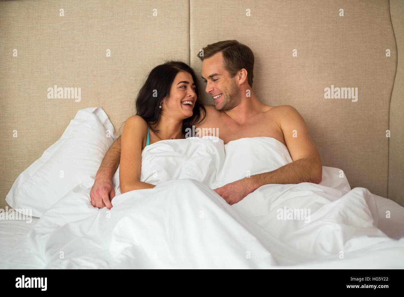 Laughing couple in bed. Stock Photo