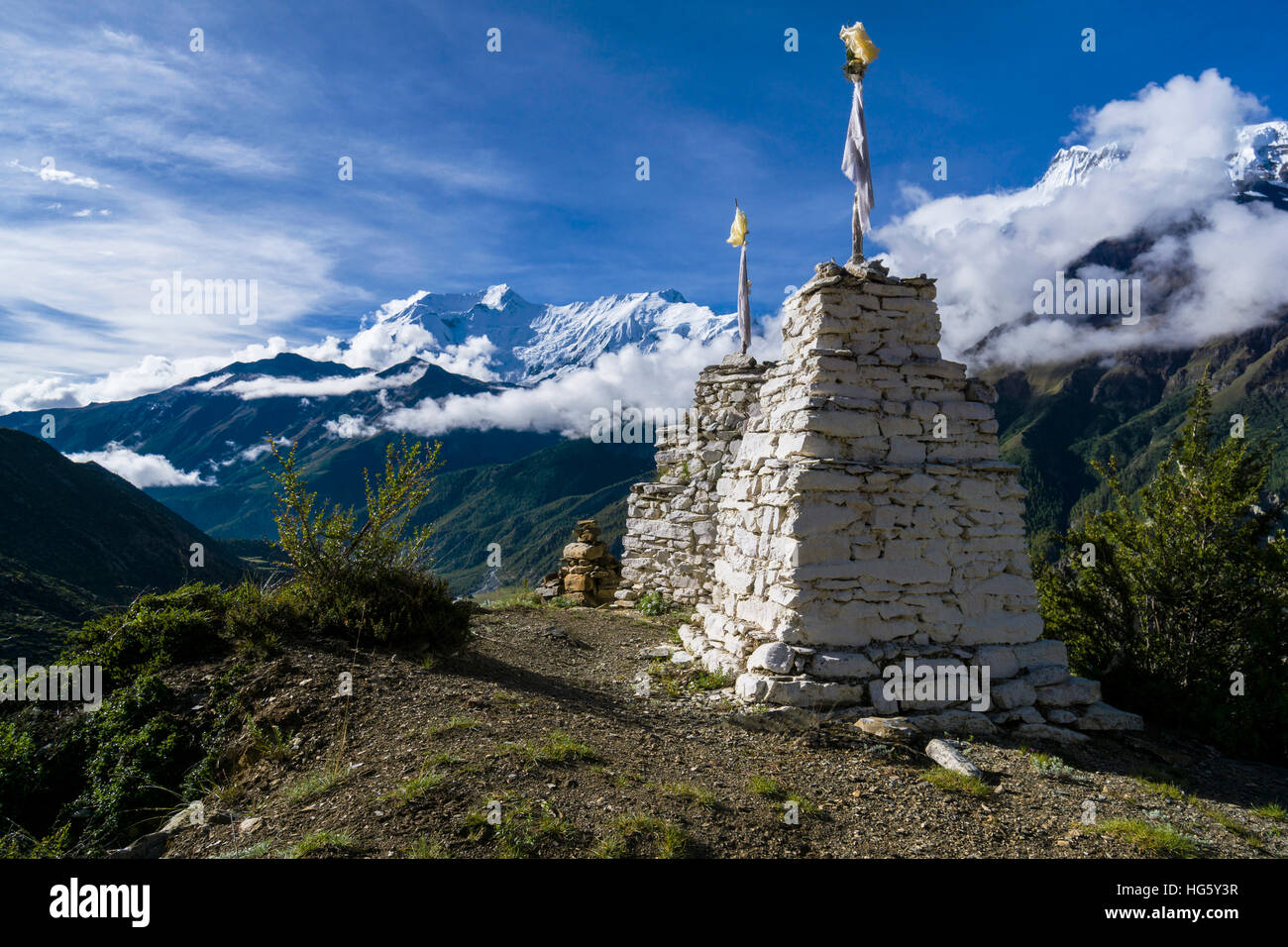 White chorten on a hill above Manang, behind Annapurna Range, Manang, Manang District, Nepal Stock Photo