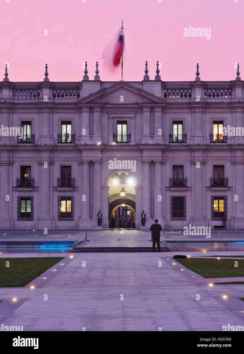 Chile, Santiago, Twilight view of La Moneda Palace from the Plaza de la Ciudadania. Stock Photo