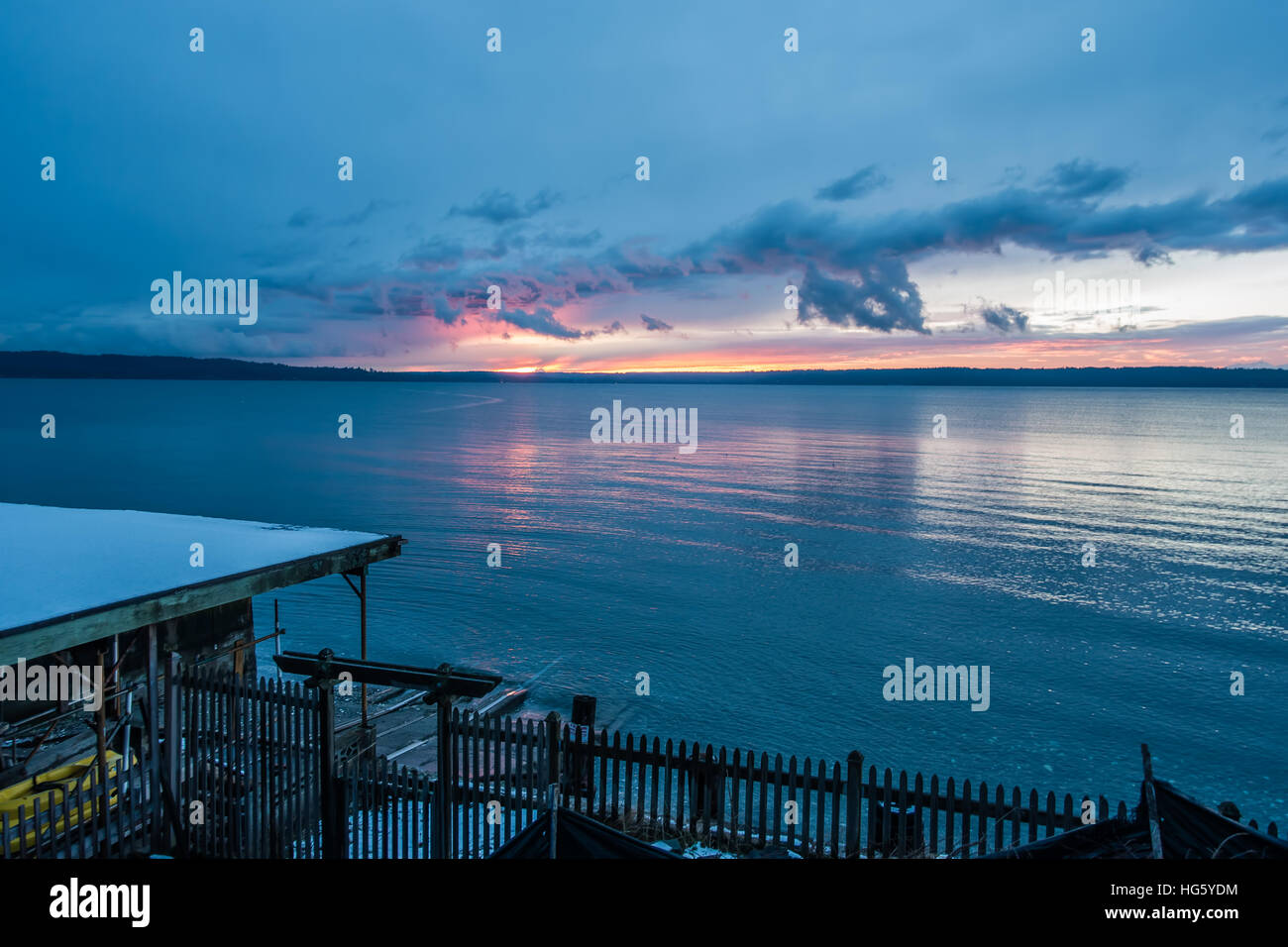 The sun sets behind the Puget Sound in winter. Stock Photo