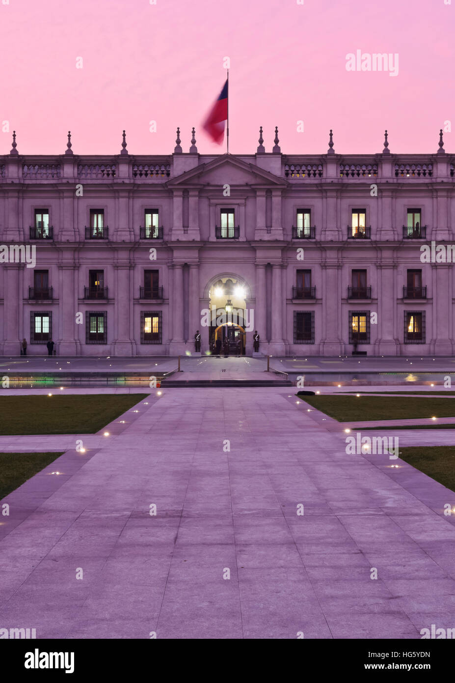Chile, Santiago, Twilight view of La Moneda Palace from the Plaza de la Ciudadania. Stock Photo
