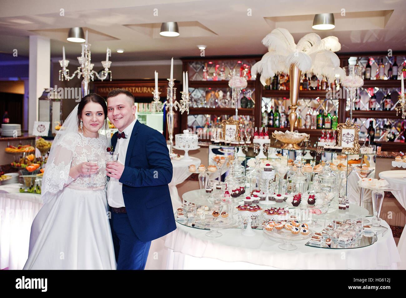 Wedding couple posed background wedding reception Stock Photo - Alamy