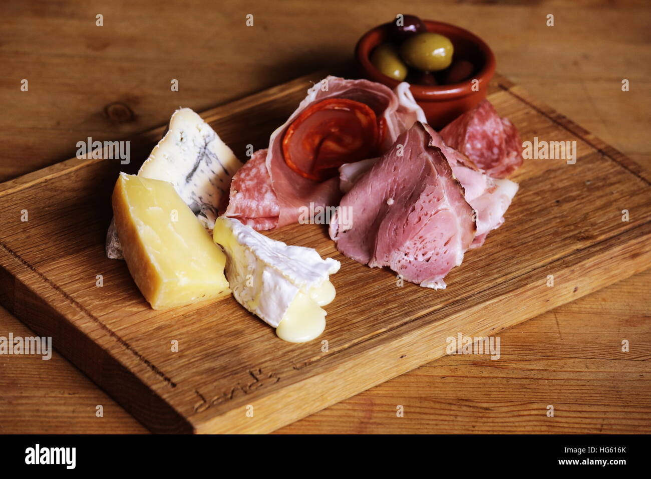 Charcuterie board with cheese, cured meat and olives Stock Photo