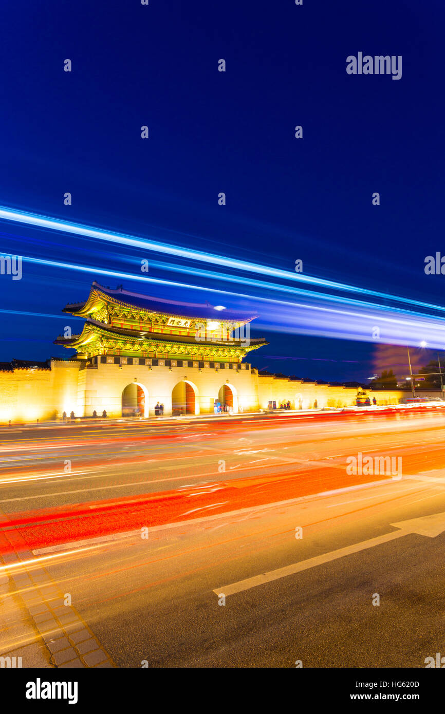 Colorful streaks of light from car lights on moving traffic in front of historic Gyeongbokgung Palace, Gwanghwamun entrance gate Stock Photo