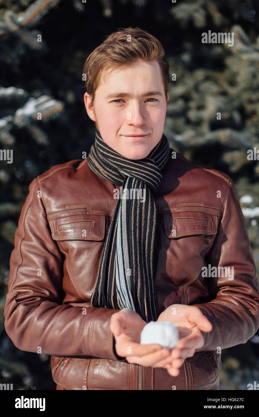 Man playing snowballs in sunny winter day Stock Photo Alamy
