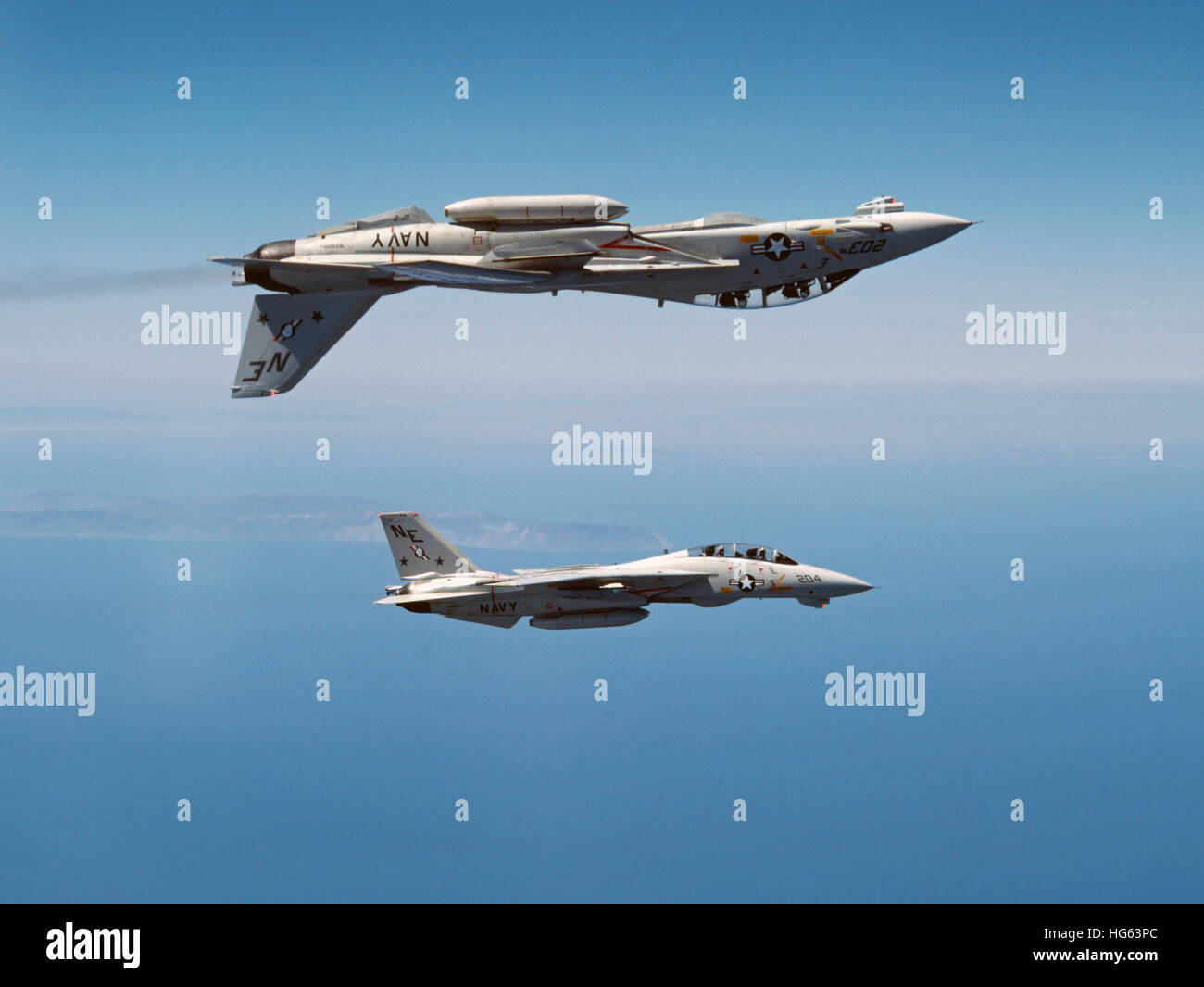 Two F-14A Tomcats perform aerobatics above the Pacific Ocean. Stock Photo