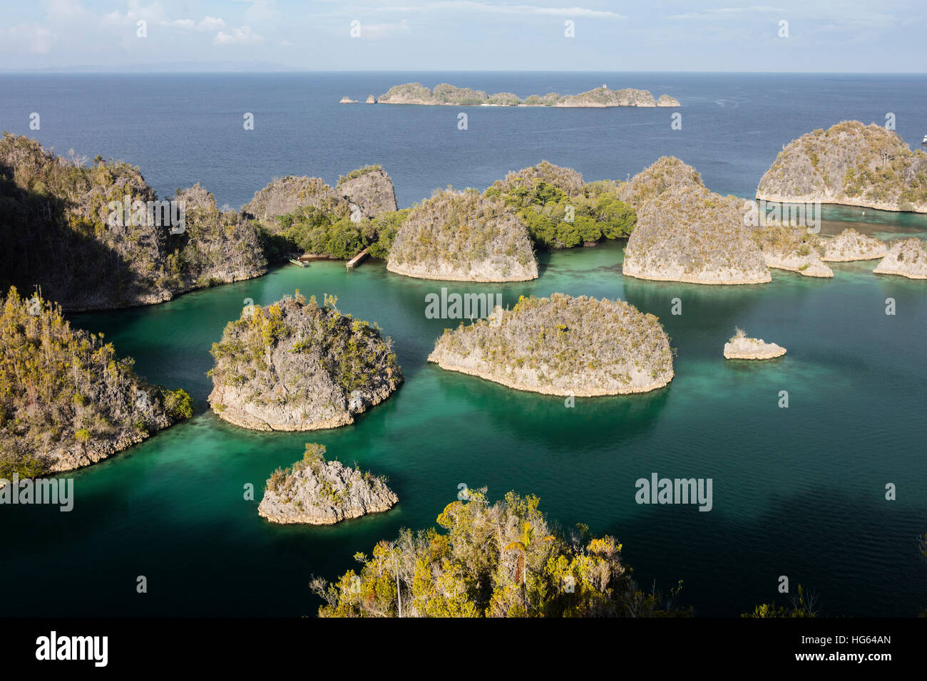 Limestone islands surround a beautiful lagoon in Raja Ampat, Indonesia. Stock Photo