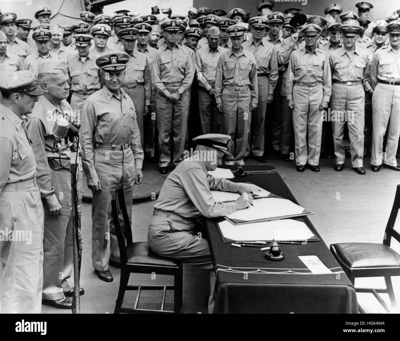 Admiral Chester Nimitz signing the Japanese surrender documents aboard USS Missouri. Stock Photo