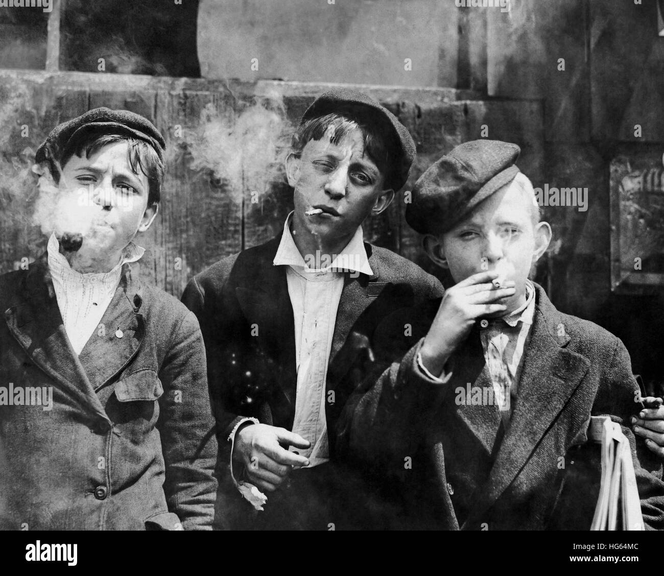 Missouri newsboys smoking on a street in St. Louis, 1910. Stock Photo