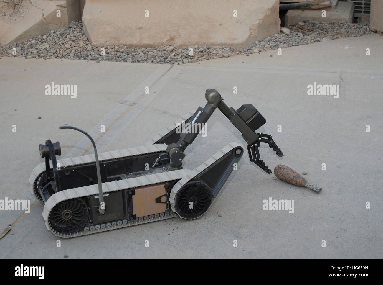 A PackBot robot picks up a demonstration object in Baghdad, Iraq. Stock Photo