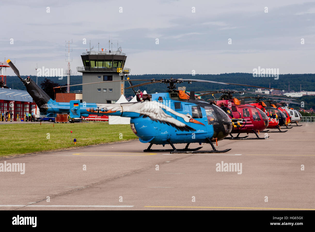 A line-up of 5 special colored Bo-105 helicopters of the German Army. Stock Photo