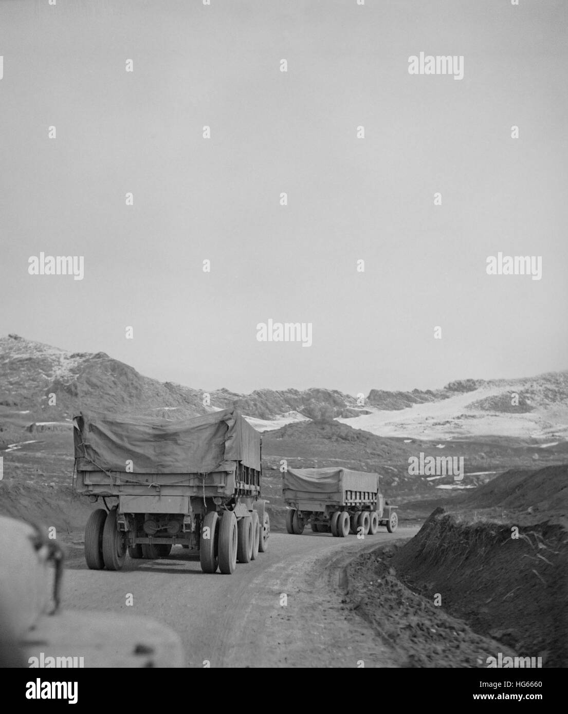A U.S. Army truck convoy climbing a mountain pass somewhere in the Persian corridor, 1943. Stock Photo