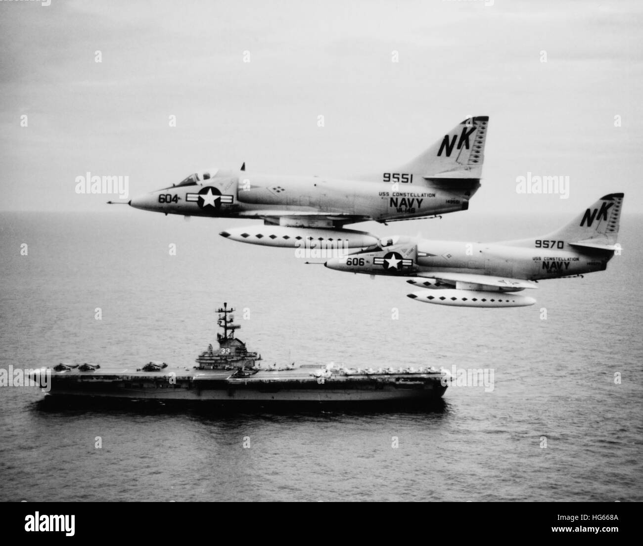 Two A-4C Skyhawk aircraft fly past anti-submarine aircraft carrier USS Kearsarge, 1964 Stock Photo