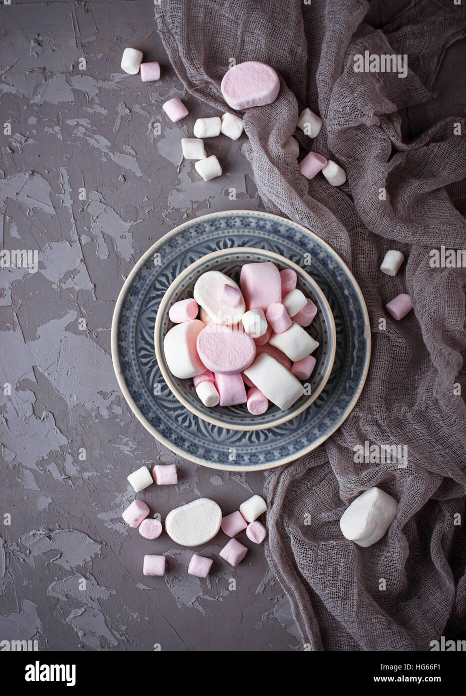 White and pink marshmallows on gray concrete background. Selective focus Stock Photo