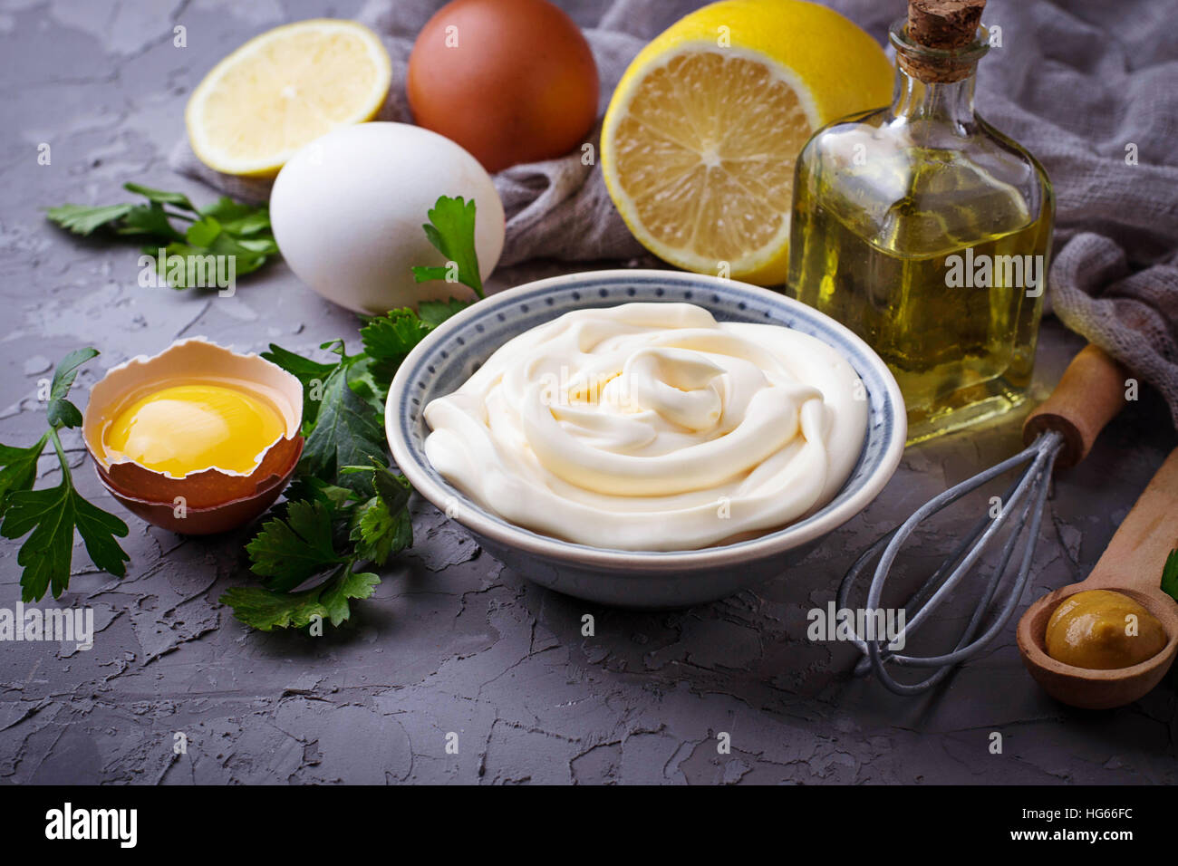 Homemade mayonnaise sauce and olive oil, eggs, mustard, lemon. Selective focus Stock Photo