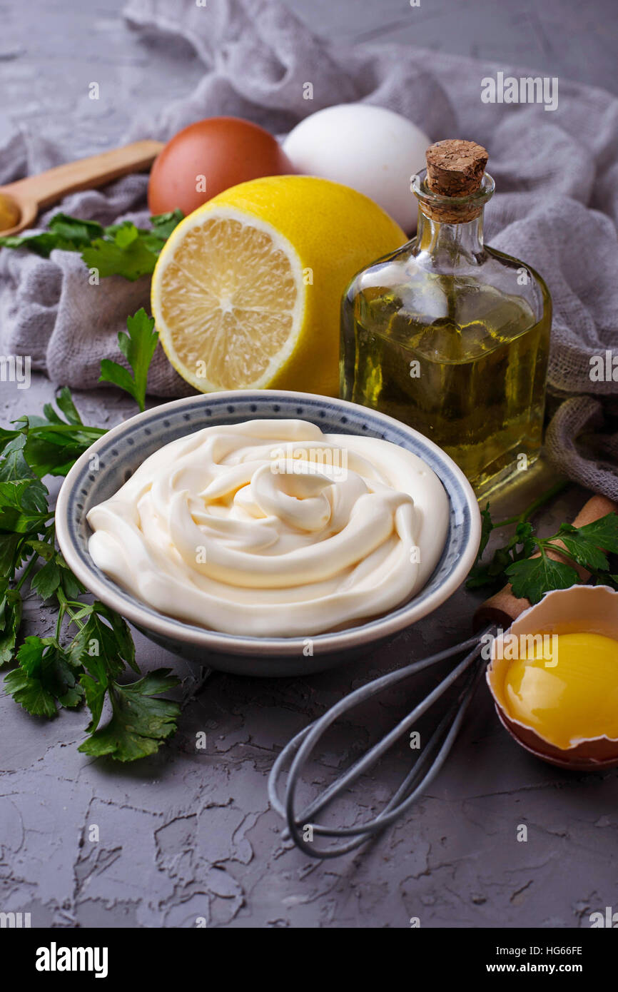 Homemade mayonnaise sauce and olive oil, eggs, mustard, lemon. Selective focus Stock Photo