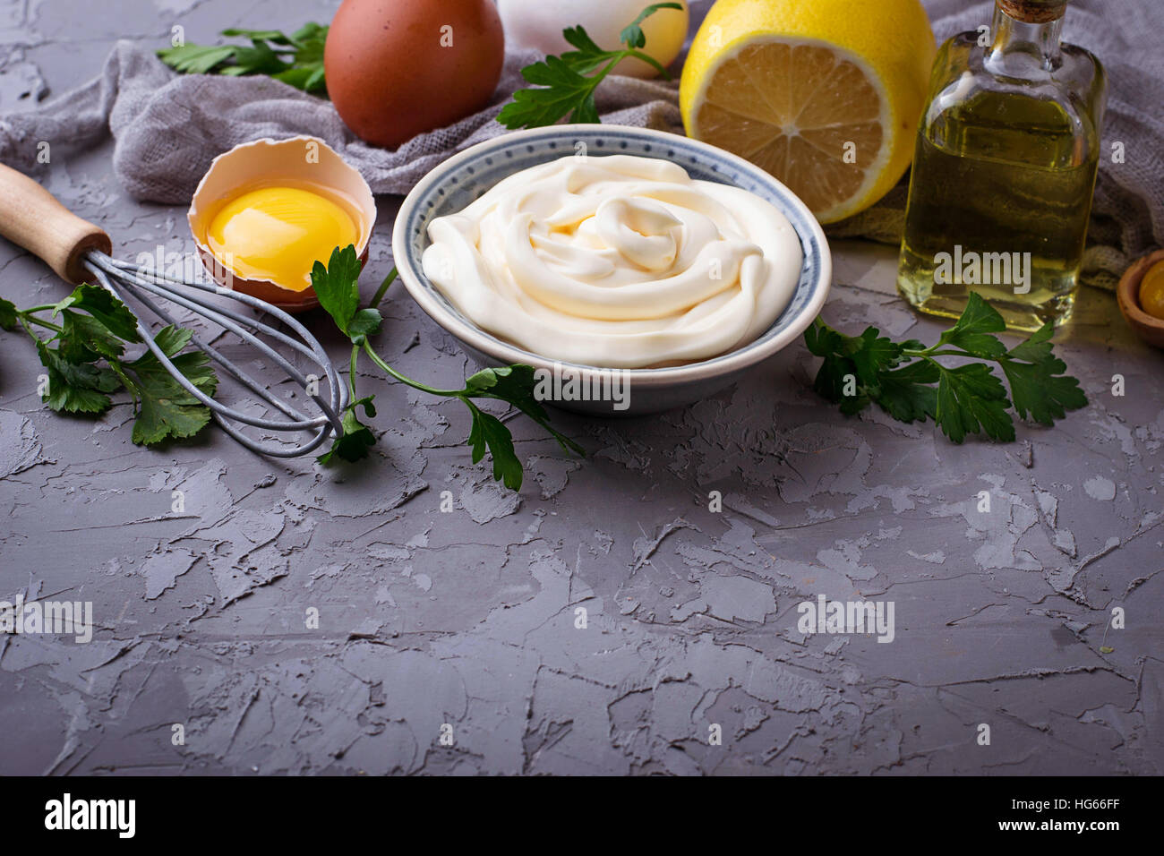 Homemade mayonnaise sauce and olive oil, eggs, mustard, lemon. Selective focus Stock Photo